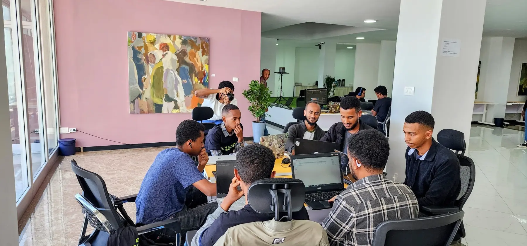 Participants collaborating around laptops at the first CyberShield event in 2023